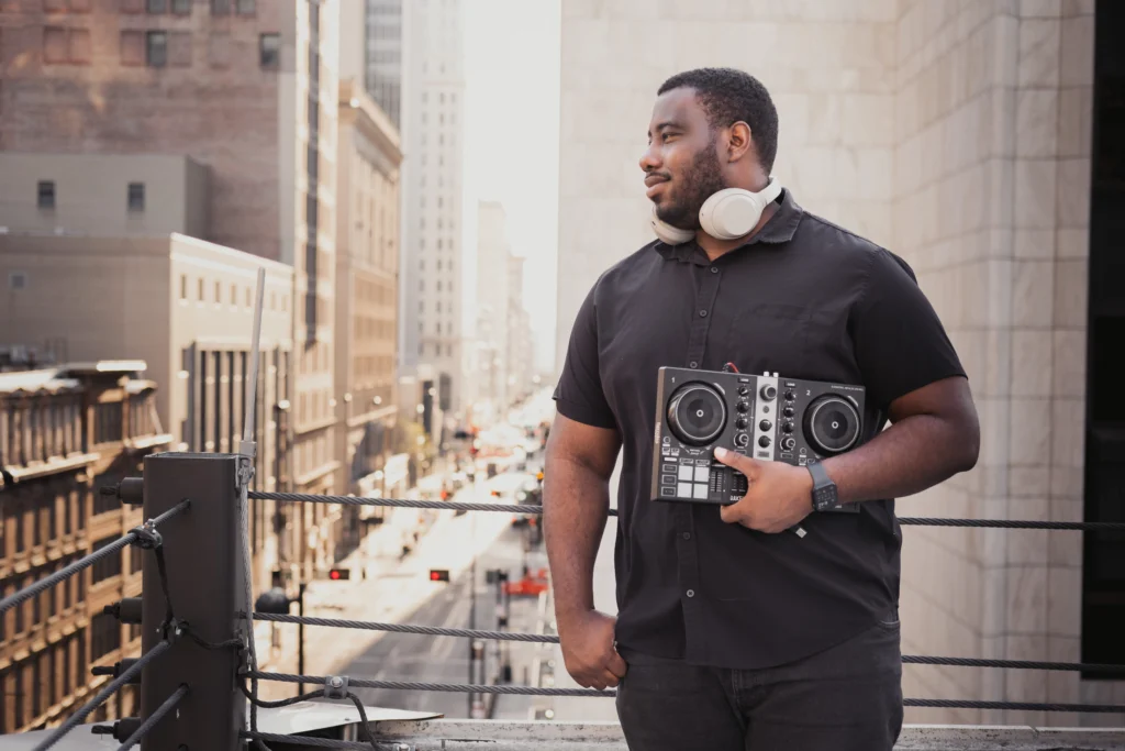 man entrepreneur posing on a Cincinnati rooftop with a dj set