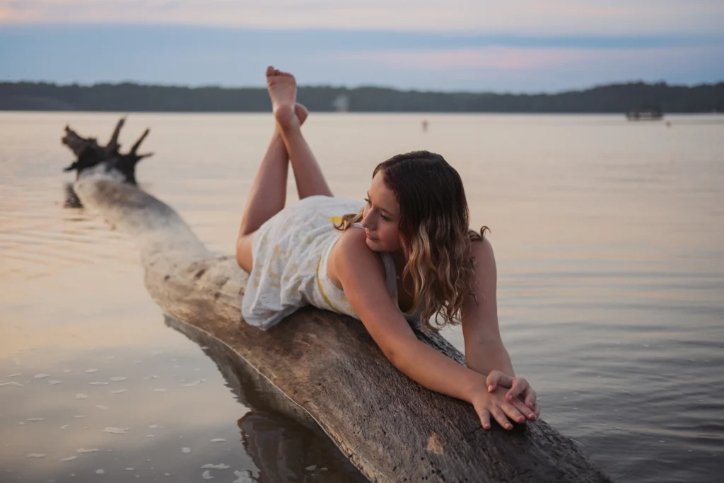 a Cincinnati high school senior posing on a lake