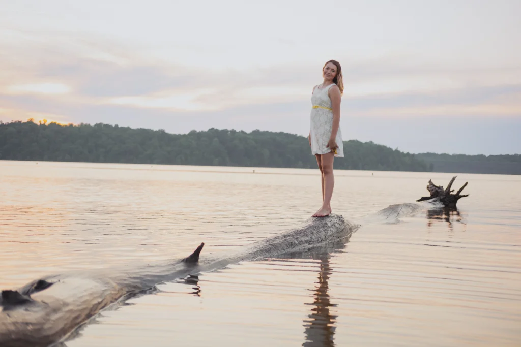 a Cincinnati high school senior posing on a lake