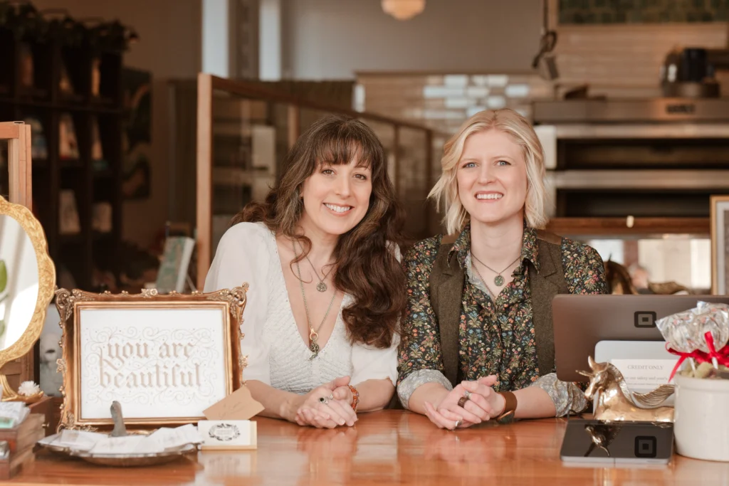 two women entrepreneurs posing at their Newport, Ky business