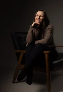 A woman sitting on a chair posing for a photo session
