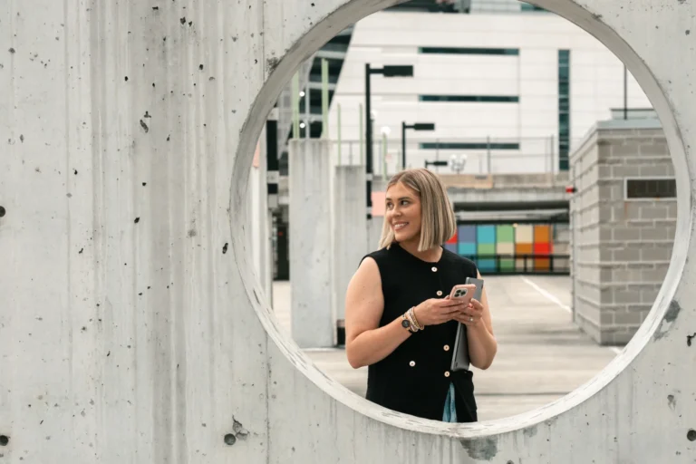 woman looking off camera with laptop in her hand branding photo session at sawyer point cincinnati ohio