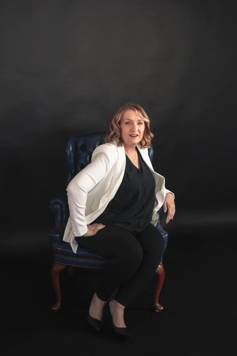 woman sitting in a chair dressed in a white suit newport kentucky branding session