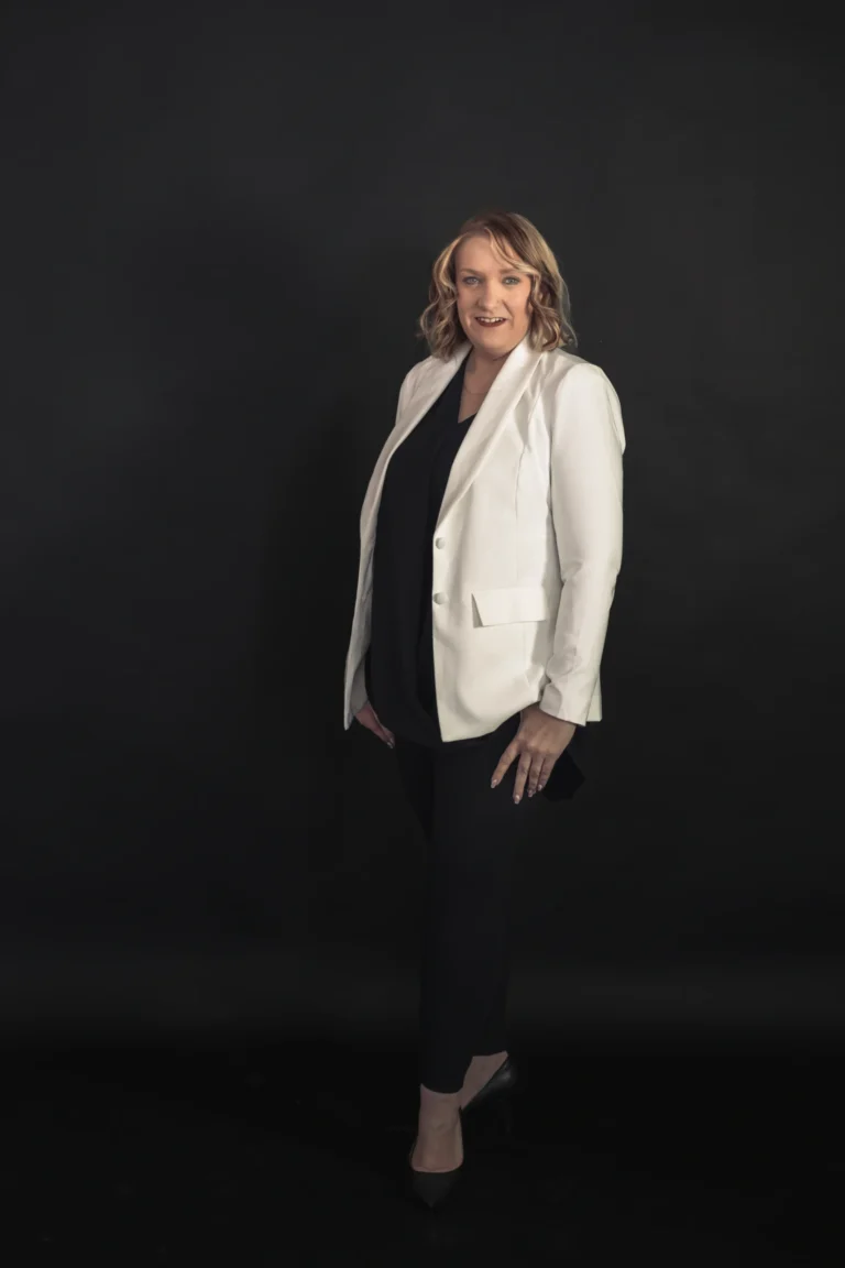 woman stands dressed in a white suit newport kentucky branding session