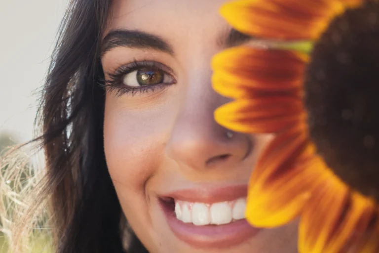 close up portrait of a woman with sunflower during a senior portrait session at clover farm near cincinnati ohio