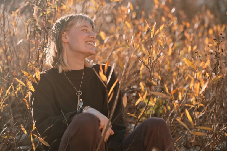 portrait of a woman during a fall senior photo session on little miami river near mariemont ohio