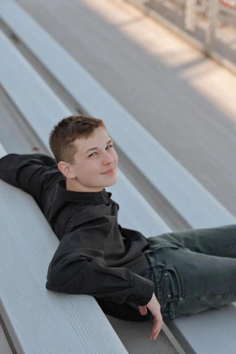 senior photo session at West Clermont High School Batavia ohio student sitting relaxed at a bench