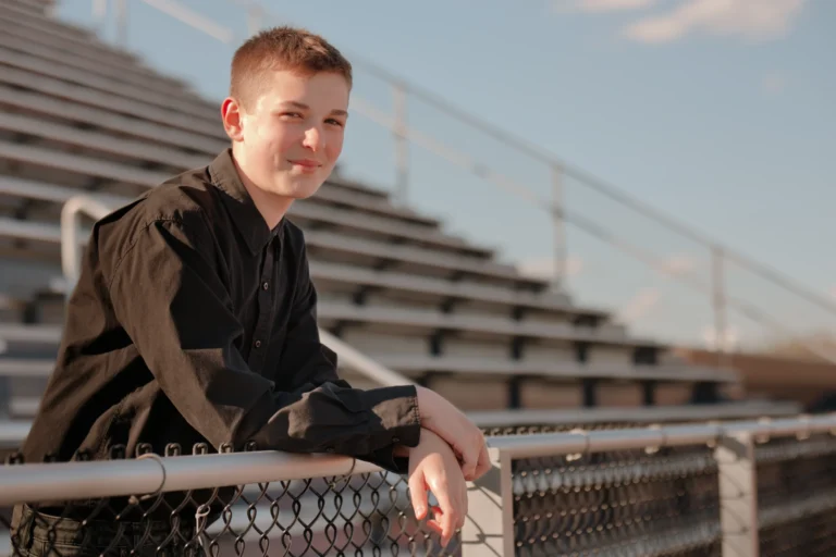 senior photo session at West Clermont High School Batavia ohio student standing at the bleechers