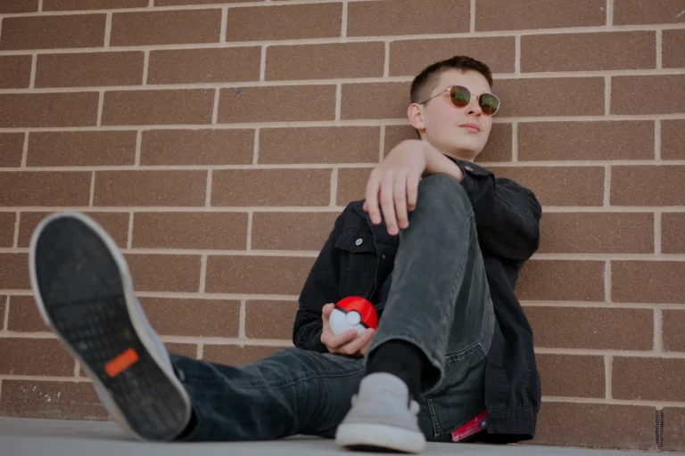senior photo session at West Clermont High School Batavia ohio student sitting by brick wall