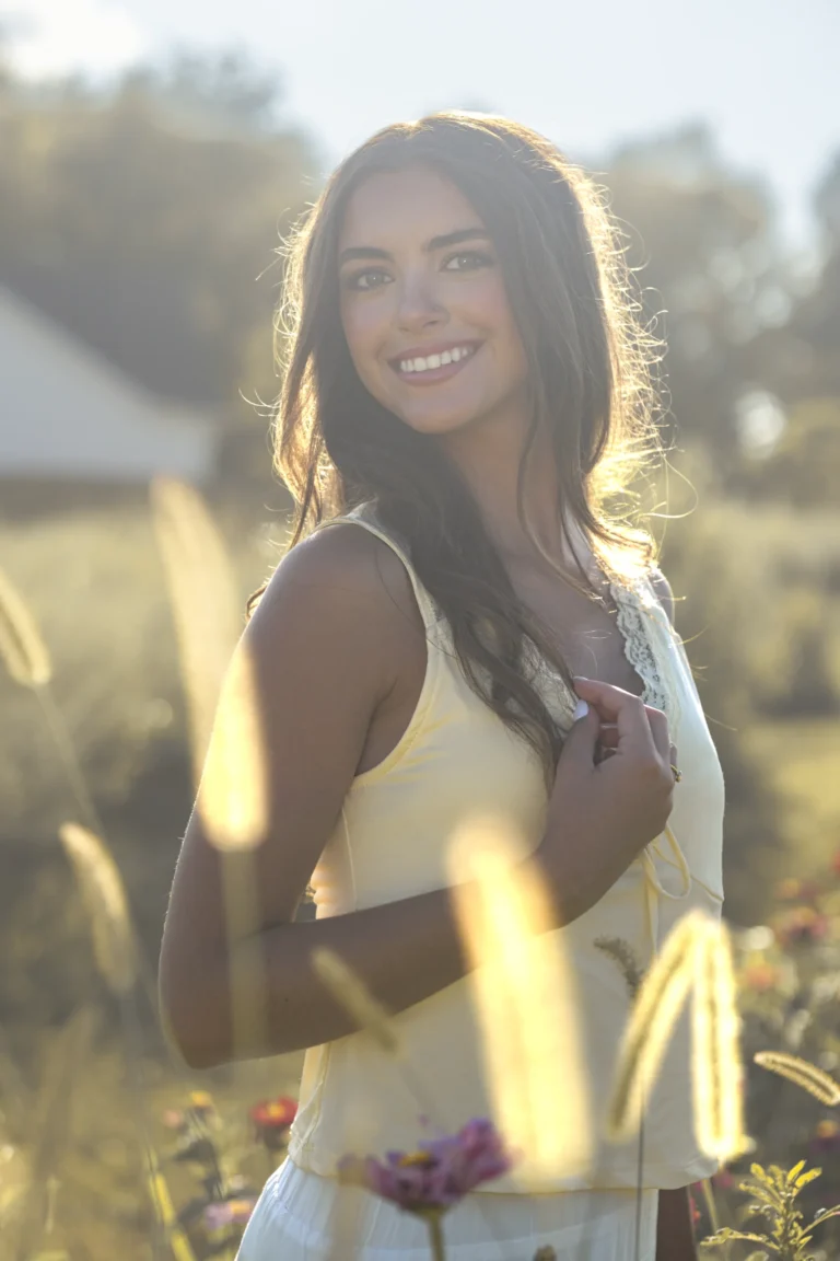 senior smiling at the camera during sunset photoshoot at Clover farm near Batavia Ohio and Cincinnati